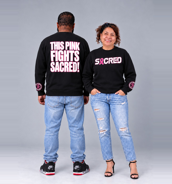 Twink and Anna showing the front and back of the Sacred Fight Cancer crewneck with THIS PINK FIGHTS SACRED! back print